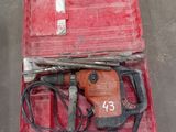 a red tool case with a hammer and other tools in it