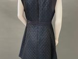 a mannequin wearing a black dress with a collared neckline