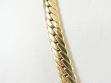 a close up of a gold necklace on a mannequin mannequin mannequin mannequin mannequin mannequin mannequin manne