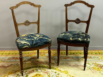 pair of antique chairs with upholstered upholstered cushions