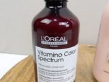 a bottle of vitamin color sham next to a bottle of sham