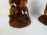 two wooden sculptures of horses and a man on a horse