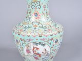 a blue vase with a picture of a man and a woman on it