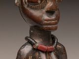 a close up of a statue of a woman with a necklace on her neck