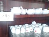 many cups and saucers on the shelves in the store
