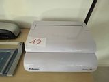 a printer sitting on top of a desk next to a laptop