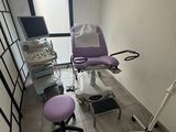 a room with a chair, a computer, and a monitor