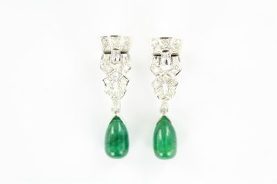 a pair of emerald and diamond earrings