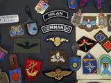 a lot of military badges on a black table