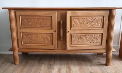 une armoire en bois dont les portes sont ornées de sculptures