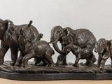 a statue of a family of elephants on a table