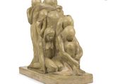 sculpture of a group of people sitting on a wooden base