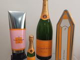 three bottles of champagne and a bottle of hand cream on a table