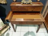 a small desk with a clock on top of it