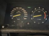 a close up of a car dashboard with a speedometer and gauges