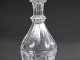 a clear glass bottle with a clear top on a black background