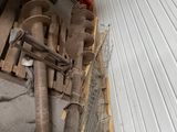 a pile of pipes and other items in a garage