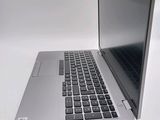 a silver laptop with a black keyboard on a white surface
