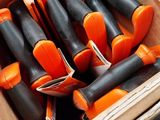 a box full of orange and black screwdrivers in it