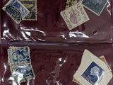 many stamps in a red bag on the table