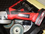 a red and black electric tool sitting in a tool box