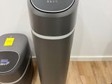two trash cans sitting next to each other on the floor