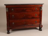 an antique chest of drawers with a marble top