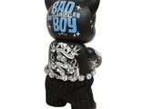 the black cat is wearing a shirt and pants with a chain around it ' s neck