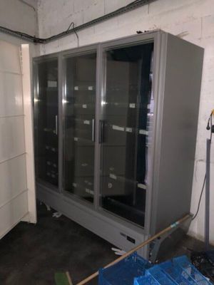 an image of a refrigerator in a room with a lot of boxes