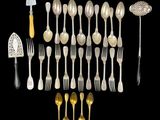 a group of silverware including forks, spoons and spatulas