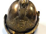 a metal helmet with a chain around it on a white surface