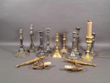 a lot of candles and candlesticks on the table