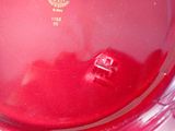 a red bowl that has a gold emblem on it