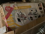 a cardboard box with a toy kitchen set in it