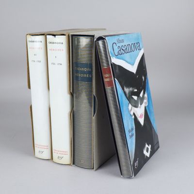 three books are stacked on top of each other on a gray surface