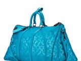 the large blue bag is sitting on a white surface