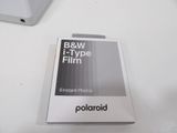 a box of polaroid film sitting on a table next to a laptop