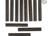 an image of a set of six wooden sticks with a gold design