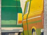 a painting of a van and a van on the side of a building