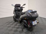 a motorcycle that is parked on a checkered floor