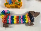 a wooden toy of a dachshund on a table