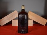 a bottle of wine sitting on a table next to a wooden box