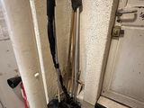 two brooms that are sitting on the floor next to a door