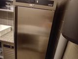 a stainless steel refrigerator in the corner of a kitchen