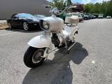 a white motorcycle parked on the side of the road