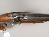 a close up of a gun on a white surface with a tag