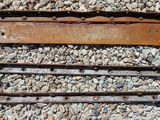 a rusted piece of metal sitting on a pile of rocks