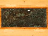 painting of a blackboard in a wooden frame on a wall
