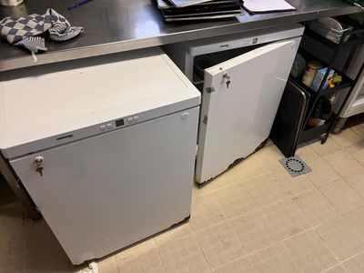 a kitchen with a sink and a refrigerator in it