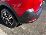a close up of a red car parked in a parking lot